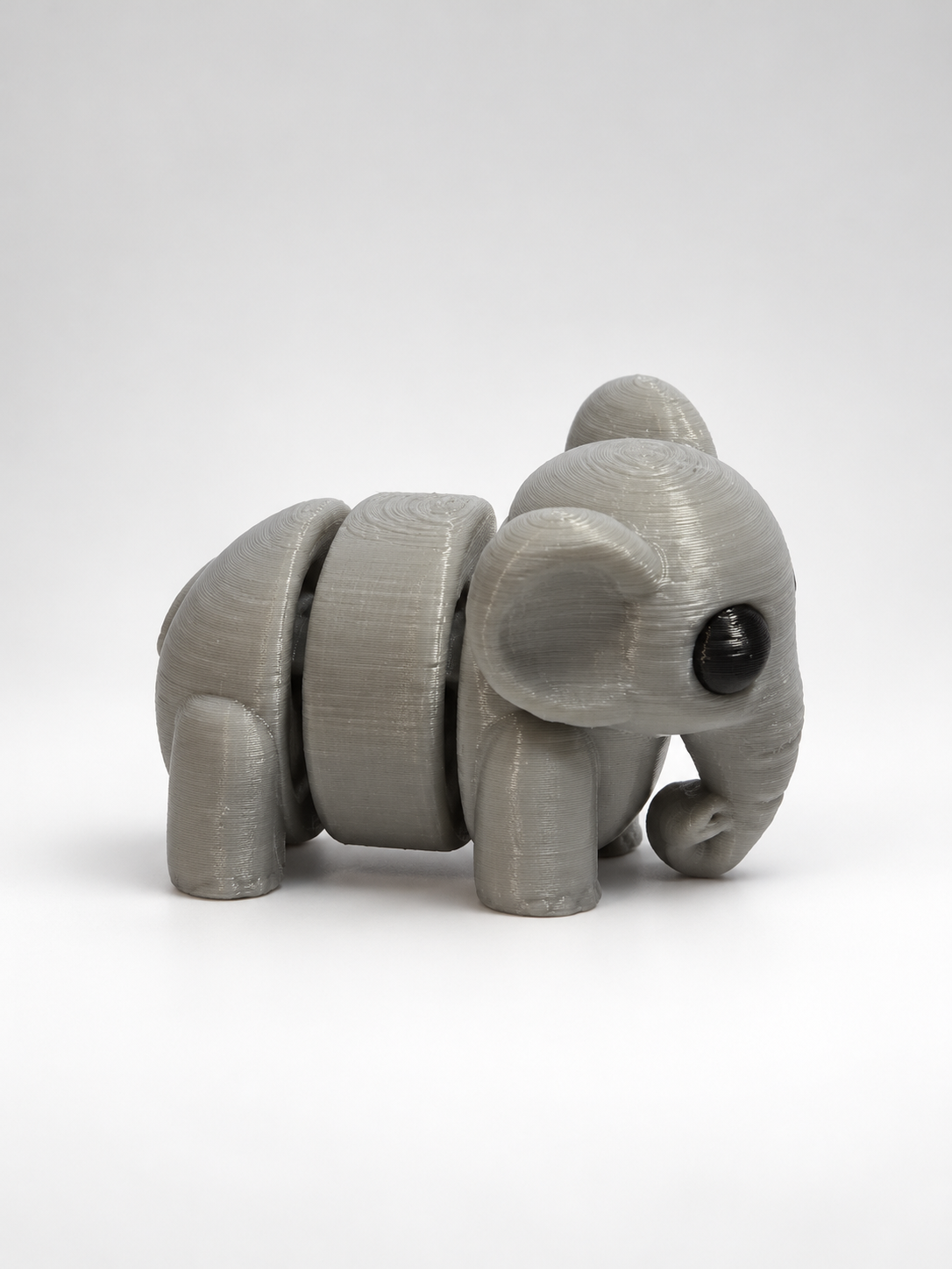 Grey articulated elephant side view highlighting segmented body